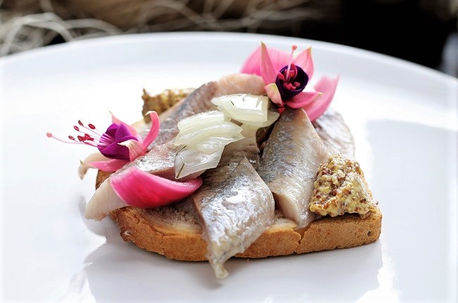herring with fuchsia edible flower
