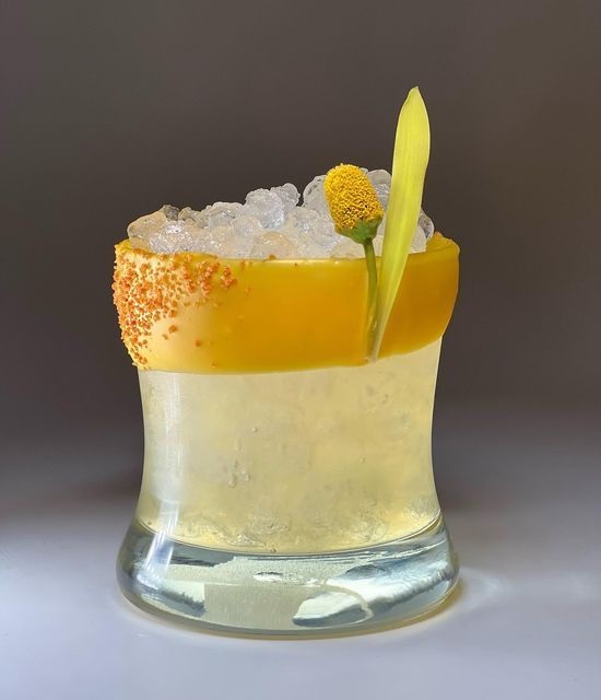 cocktail with Buzz Button garnish