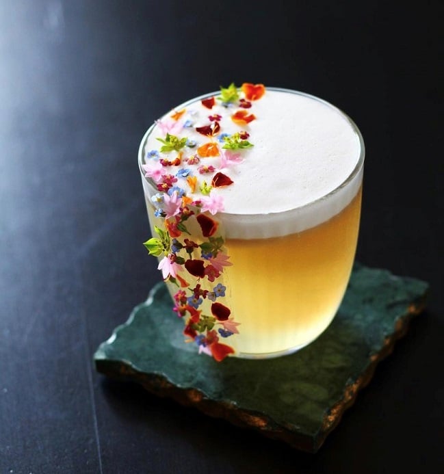 Cocktail with edible flower garnish