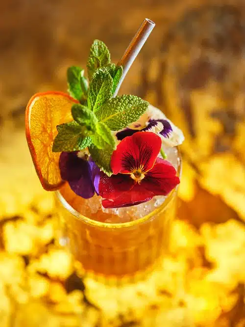 mocktails with ginger beer garnished with edible flowers